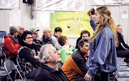 Christine Nelson holds up a jar of pickles during the Lyle Area Cancer Auction last year. Herald file photo