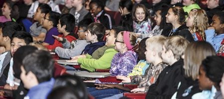 I.J. Holton Intermediate School students laugh as Professor Scientificus, played by Chris Griffith, takes them through a song on Minnesota inventions Friday afternoon at Ellis Middle School. Eric Johnson/photodesk@austindailyherald.com