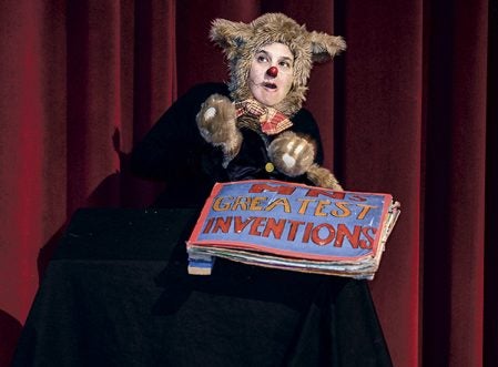 The cat Walter Mondale, played by Shari Aronson points out a book of Minnesota inventions at Ellis Middle School Friday afternoon. Eric Johnson/photodesk@austindailyherald.com