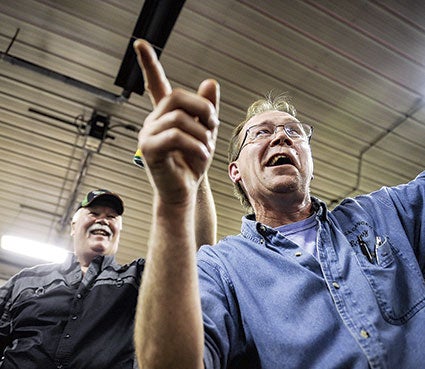 Larry Ricke winks as he points out a bid during the Lyle Area Cancer Auction Friday night in Lyle. Photos by Eric Johnson/photodesk@austindailyherald.com