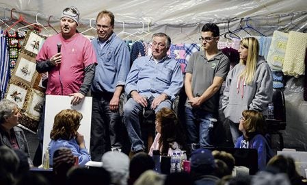 Dave Yerhart talks about his own personal fight with cancer during the Lyle Area Cancer Auction Friday night. 