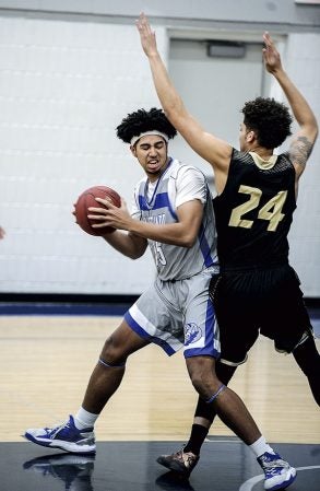 Riverland’s Donte Makazu pivots around St. Cloud Tech’s Lance Gardner during the first half Wednesday night at RCC. Eric Johnson/photodesk@austindailyherald.com