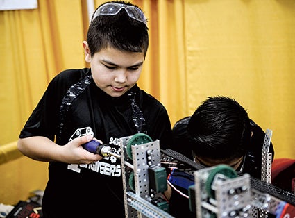 Brandon Carlson of the Ellis Engineers tweeks his team’s robot during the Austin Public Schools and Riverland College Southern Minnesota VEX Robotic Competition Saturday. 