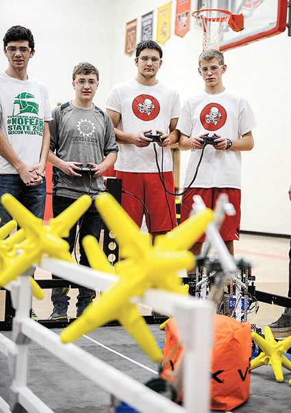 Oliver Andersen and Jacob Venenga, right, operate their robot during the Austin Public Schools and Riverland College Southern Minnesota VEX Robotic Competition Saturday in Packer Gym. 