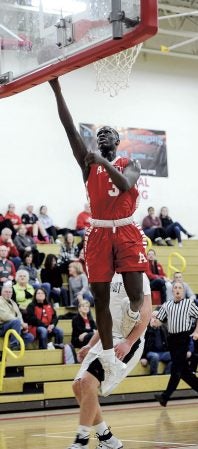 Austin’s Moses Issa gets a lay-up against Faribault in the first half Tuesday night. Eric Johnson/photodesk@austindailyherald.com