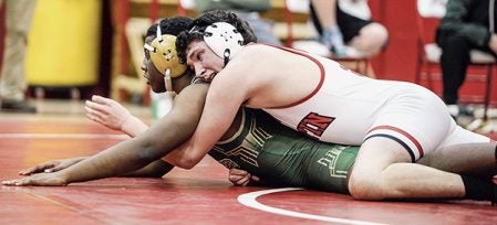 Austin’s Kaiden Igou tries to gain the advantage on Rochester Mayo’s Quincy Hill during the 182 pound match Thursday night in Ove Berven Gym. Eric Johnson/photodesk@austindailyherald.com