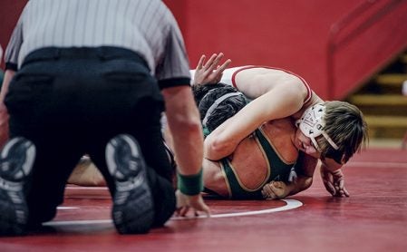 Austin’s Josh Belden works to pin Rochester Mayo’s Ethan Smith at 145 pounds Thursday night in Ove Berven Gym. Eric Johnson/photodesk@austindailyherald.com