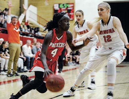 Austin’s Rebecca Younis drives on Winona’s Eden Nibbelink during the first half Friday night in Ove Berven Gym. Eric Johnson/photodesk@austindailyherald.com