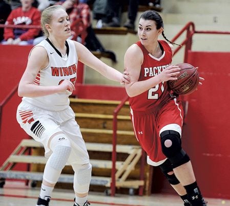 Austin’s Amber Hansen goes baseline on Winona’s Abby Winter during the first half Friday night in Ove Berven Gym. Eric Johnson/photodesk@austindailyherald.com