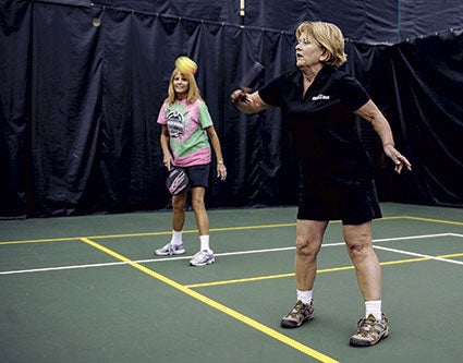 Margaret Johnson returns a ball during a game of pickleball at the YMCA. 
