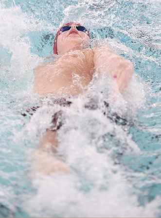 Austin’s Hugh Olson swims the backstroke during the 200 medley relay against Rochester Mayo Thursday night at Bud Higgins Pool. Eric Johnson/photodesk@austindailyherald.com