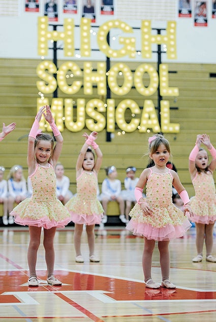 Pre-petites from Just for Kix perform in front of the High School Musical sign Saturday during the Austin Packer Dance Team Show in Packer Gym. 