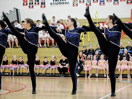 Marissa Lund, from left, Lauryn Bell and Kellie Baier perform with teh APDT high kick squad Saturday during the Austin Packer Dance Team Show in Packer Gym. 