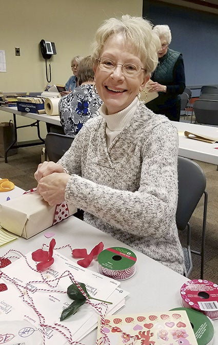 Marijo Alexander wraps a book for the upcoming “Blind Date with a Book.” Photo provided