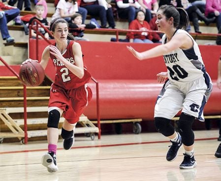 Austin’s Colie Justice moves the ball into the corner against Rochester Century’s Haylee Crosby during the second half Thursday night. Eric Johnson/photodesk@austindailyherald.com