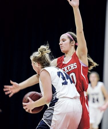 Austin’s Elyse Hebrink pressures Rochester Century’s Samantha Jorgenson during the first half Thursday night. Eric Johnson/photodesk@austindailyherald.com