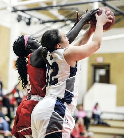 Austin’s Rebecca Younis reaches for the ball with Rochester Century’s Kiara Lindsey during the first half Thursday night in Ove Berven Gym. Eric Johnson/photodesk@austindailyherald.com