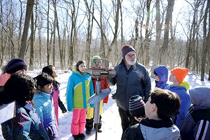 Dolphin leads a group of I.J. students as he shows them how banding is done. 