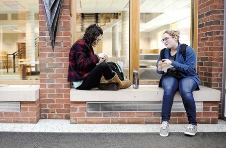 Sid Conway, left, and Emma Steinbrink, both Riverland Community College students, enjoy muffins that were given to them as part of Random Acts of Kindness Day Friday. Eric Johnson/photodesk@austindailyherald.com