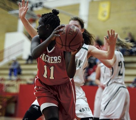 Awenia Nywesh looks to outlet from underneath the basket in the first half against Rochester Mayo Tuesday night in Ove Berven Gym. Eric Johnson/photodesk@austindailyherald.com