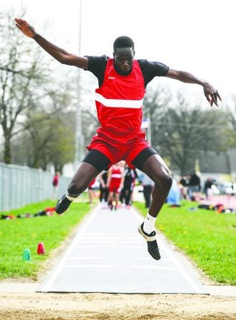 Austin’s Jany Gash competes in the long jump during the Packer Invite last April. Herald file photo