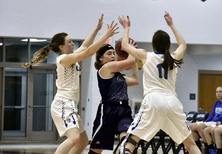 Grand Meadow’s Masie Voigt handles the ball under pressure against Winona Cotter in Grand Meadow Monday. Rocky Hulne/sports@austindailyherald.com