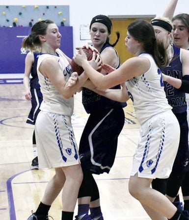 Grand Meadow’s Allie Sloan fights for a loose ball against Winona Cotter in Grand Meadow Monday. Rocky Hulne/sports@austindailyherald.com