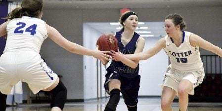 Grand Meadow’s Skylar Cotten is double teamed by Isabel Northrop, right, and Josie Huelskamp against Winona Cotter in Grand Meadow Monday. Rocky Hulne/sports@austindailyherald.com