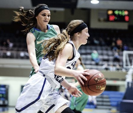 Grand Meadow’s Kaitlyn Hilton drives past Bethany Strouf during the first half in the Section 1A West semifinals Tuesday at Mayo Civic Center in Rochester. Eric Johnson/photodesk@austindailyherald.com