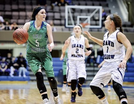 Lyle-Pacelli’s Bethany Strouf brings the ball upcourt against Grand Meadow’s Isabelle Olson during the Section 1A West semifinals at Mayo Civic Center in Rochester. Eric Johnson/photodesk@austindailyherald.com