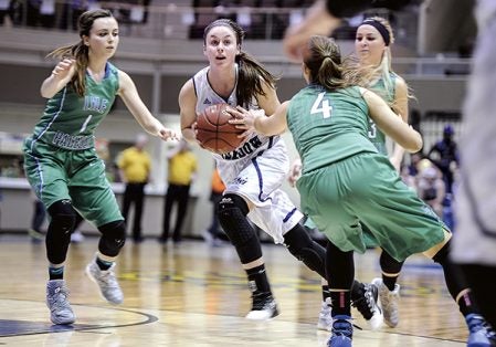 Grand Meadow’s Jordyn Glynn splits Lyle-Pacelli defenders during the first half Tuesday night in the Section 1A West semifinals at Mayo Civic Center in Rochester. Eric Johnson/photodesk@austindailyherald.com