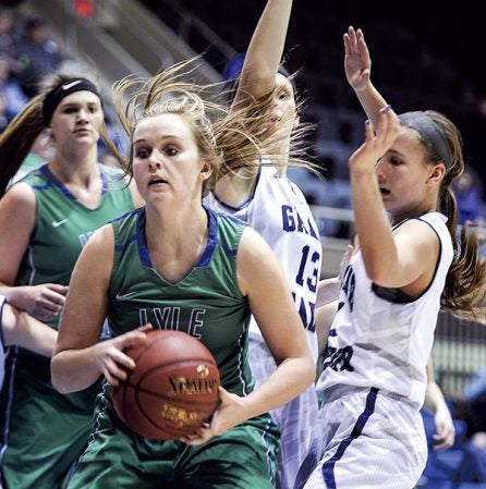 Lyle-Pacelli’s Kendal Truckenmiller holds the ball after a rebound against Grand Meadow during the Section 1A West semifinals at Mayo Civic Center in Rochester Tuesday night. Eric Johnson/photodesk@austindailyherald.com