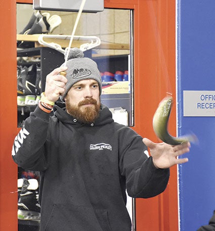 Tracy Millner snags a fish at the Jaycees booth Friday. 