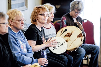 Barb Selmecki of Austin takes part in the Austin Drumming Circle’s demonstration Tuesday at the Hormel Historic Home.