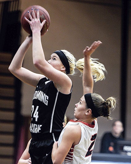 Blooming Prairie’s Marissa Larson shoots past NRHEG’s Marnie Wagner this past season. 