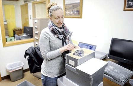 Jaimie Timm, curator of the Mower County Historical Society, shows off some of the military patches on hand at the historical Society. Eric Johnson/photodesk@austindailyherald.com