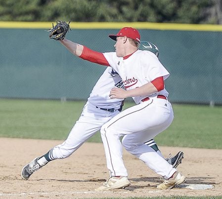 Austin first baseman Luke Hawkshead moves to slap a tag on Faribault’s Omar Escobar on a pick-off attempt Tuesday night at Dick Seltz Field. Eric Johnson/photodesk@austindailyherald.com