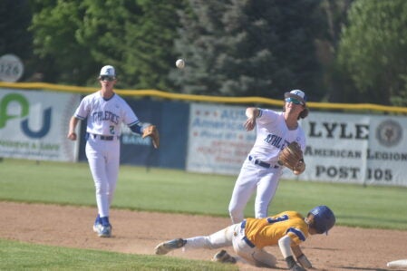 Lyle-Pacelli's Dane Schara throws over Hayfield runner Kevin Hodge. Rocky Hulne/sports@austindailyherald..com